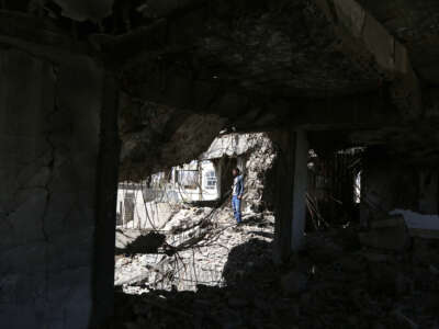 A Yemeni man inspects a house that was destroyed in an airstrike carried out during the Yemen war by the Saudi-led coalition's warplanes, on February 5, 2021, in Sana'a, Yemen.