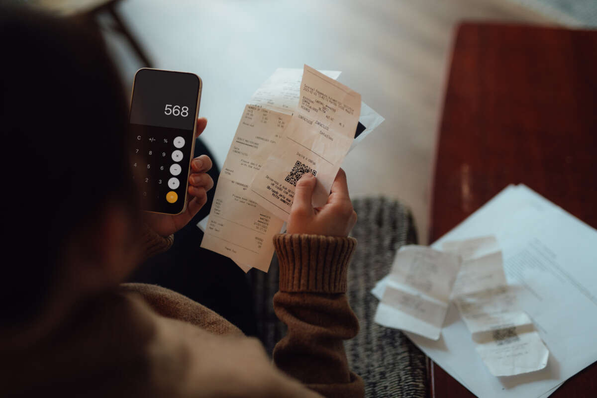 Young woman calculating financial bills at home