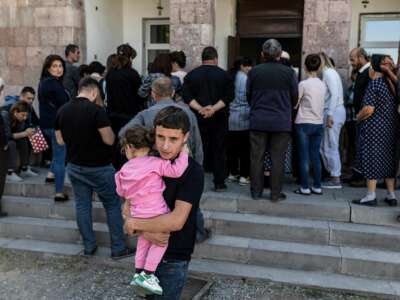 Refugees from Azerbaijan-controlled region of Nagorno-Karabakh wait for humanitarian aid in the village of Hayanist, Armenia, on October 8, 2023.