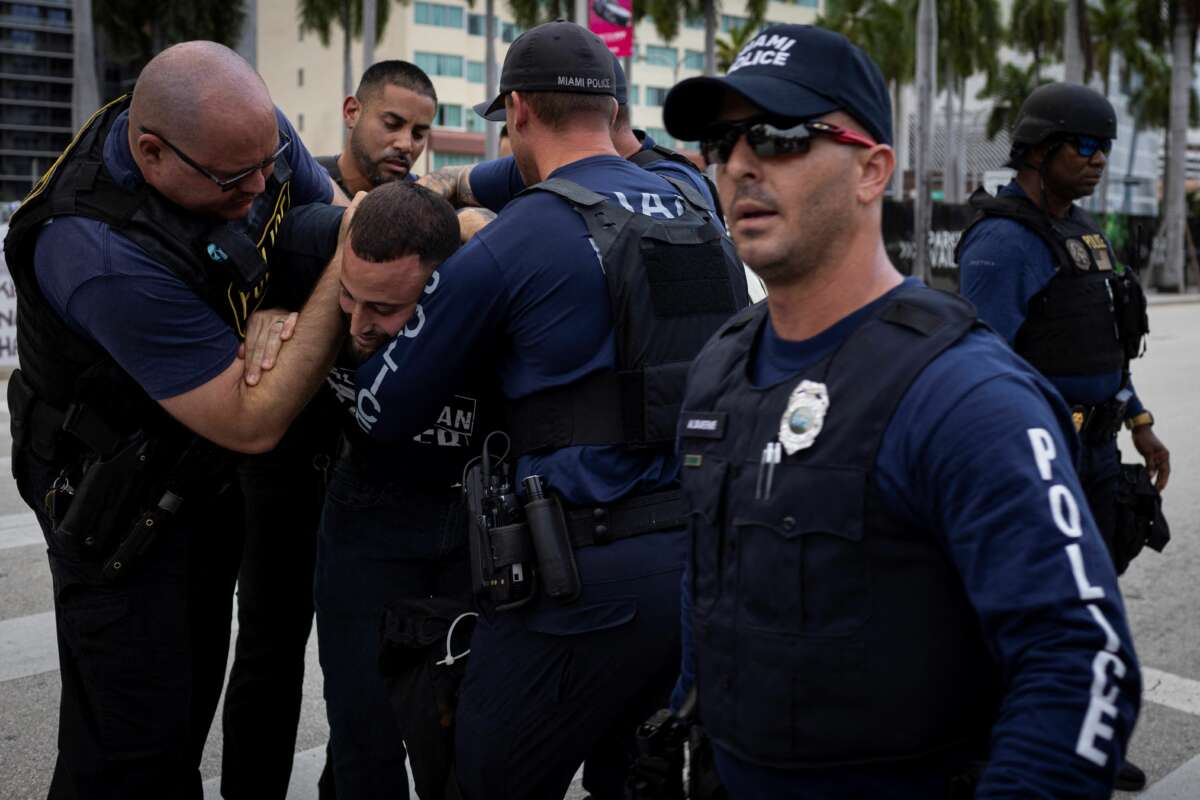 Miami police officers detain a demonstrator as people attend a rally in support of Palestinians in the Gaza Strip at Bayfront Park in Miami, Florida, on October 13, 2023.