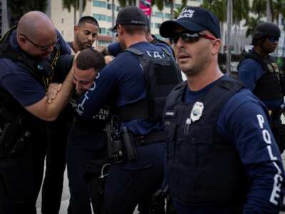 Miami police officers detain a demonstrator as people attend a rally in support of Palestinians in the Gaza Strip at Bayfront Park in Miami, Florida, on October 13, 2023.