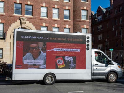 A truck calling the president of Harvard a "national disgrace" drives around Harvard University in Cambridge, Massachusetts, on December 12, 2023.