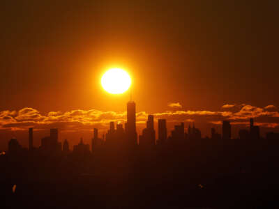 The sun rises behind the skyline of lower Manhattan and One World Trade Center in New York City, on January 21, 2024.