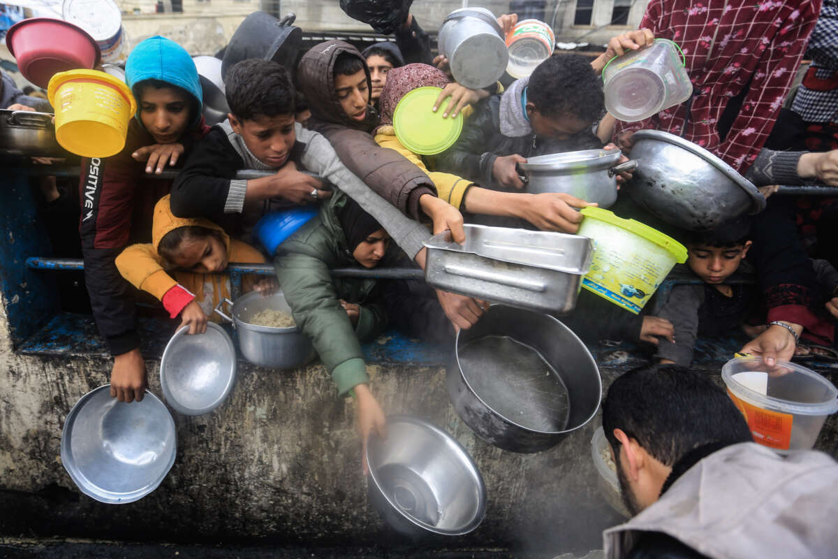 Displaced Palestinians wait to receive food on January 27, 2024, in Rafah, southern Gaza Strip.