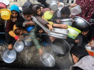 Displaced Palestinians wait to receive food on January 27, 2024, in Rafah, southern Gaza Strip.