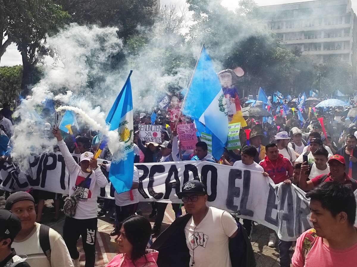 Thousands of vendors and tenants from more than 50 markets in the Guatemala City area march for democracy.