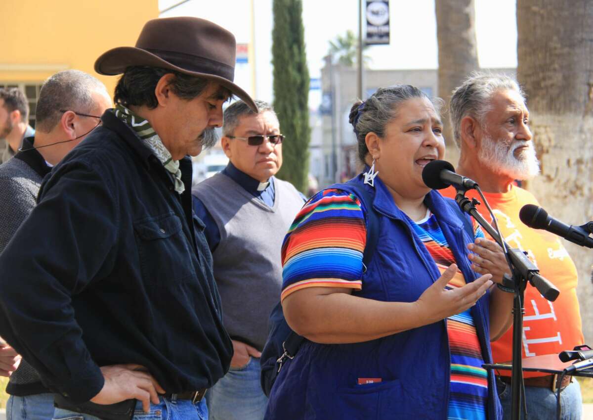 Eagle Pass residents Jessie Fuentes, Amerika García Grewal and Mike García speak out against the state of Texas’s seizure Shelby Park at the historic Maverick County Courthouse on February 2, 2024, in Eagle Pass, Texas.