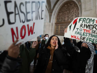 Pro-Palestine demonstrators rally in the lobby of City Hall while the City Council debates a symbolic resolution calling for a ceasefire in the war between Israel and Hamas on January 31, 2024, in Chicago, Illinois.