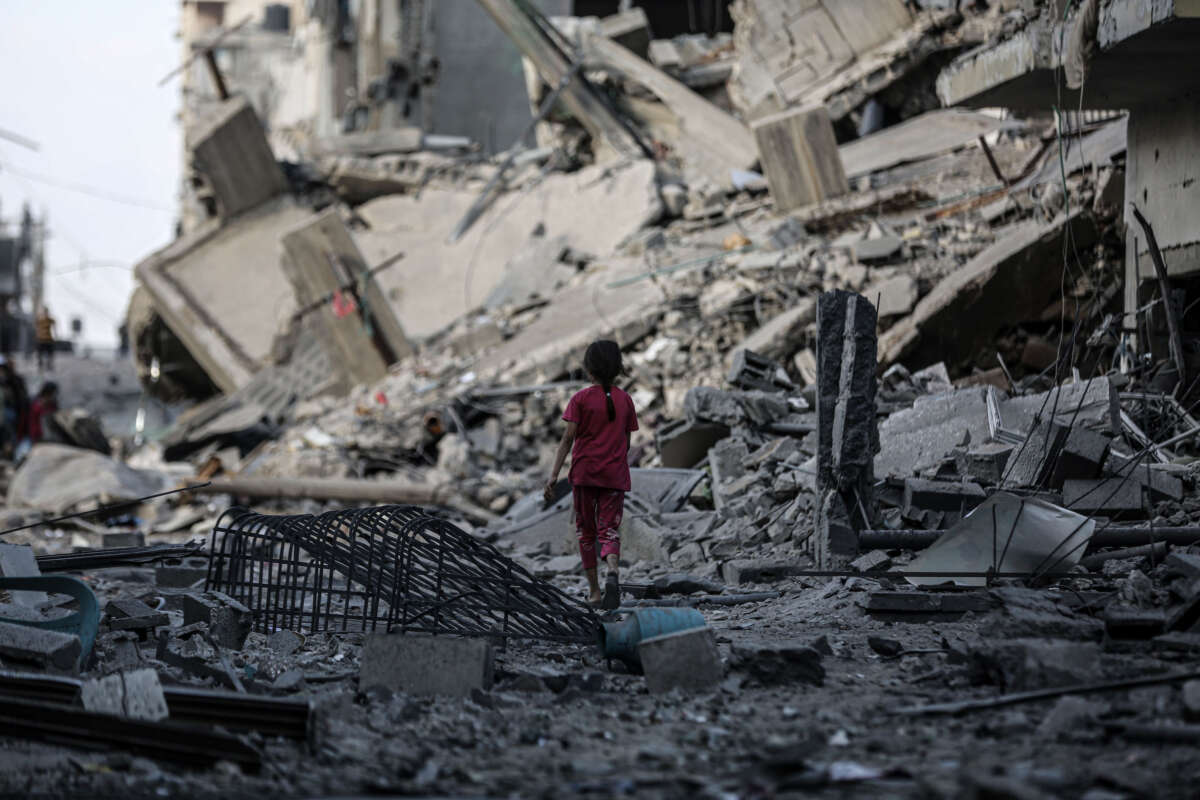A Palestinian child walks through debris following Israeli bombardments on the southern part of Gaza City, Gaza, on October 16, 2023.