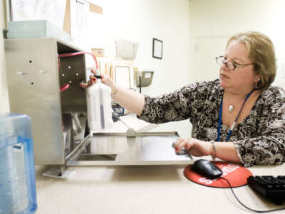 Michelle Morin, a registered nurse at Merrimack River Medical Services, administers methodone at a dosing window, in Portland, Maine, on January 9, 2008.