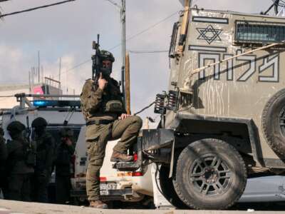 An idf soldier poses with a gun