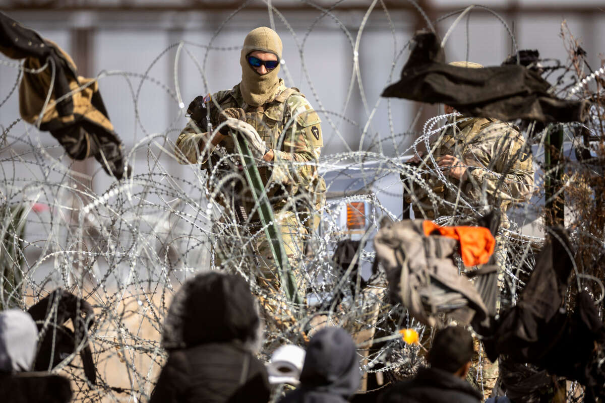 Texas National Guard troops reinforce razor wire after immigrants crossed the Rio Grande into El Paso, Texas, on January 30, 2024, from Ciudad Juarez, Mexico.