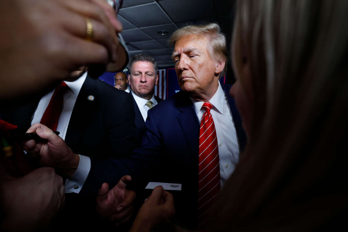 Former President Donald Trump signs autographs and shakes hands with supporters at the conclusion of a campaign rally in the basement ballroom of The Margate Resort on January 22, 2024, in Laconia, New Hampshire.