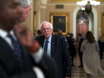 Sen. Bernie Sanders makes his way to the Senate chamber, pausing as a colleague speaks about Israel, on Capitol Hill on December 12, 2023, in Washington, D.C.