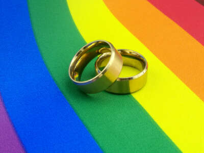 Wedding rings on rainbow, marriage equality concept