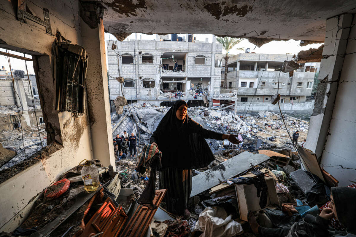 A woman inspects the destroyed building of Palestinian journalist Adel Zorob, who was killed overnight in an Israeli bombardment, in Rafah in the southern Gaza Strip on December 19, 2023.