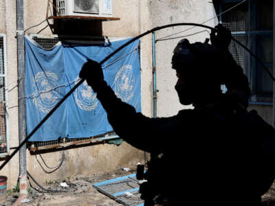 This picture taken during a media tour organized by the Israeli army on February 8, 2024, shows an Israeli soldier standing in an evacuated compound of the United Nations Relief and Works Agency for Palestine Refugees (UNRWA) in Gaza City.