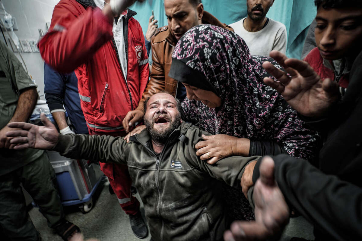A Palestinian father mourns for his child, who died following an Israeli attack, as bodies of the deceased are brought to Nasser Hospital in Khan Yunis, Gaza, on January 6, 2024.