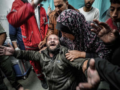 A Palestinian father mourns for his child, who died following an Israeli attack, as bodies of the deceased are brought to Nasser Hospital in Khan Yunis, Gaza, on January 6, 2024.