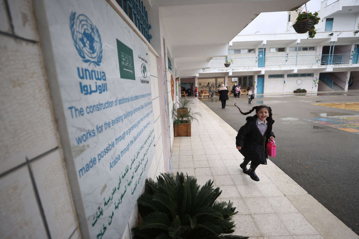 A Palestinian student walks out of a UNRWA school with a lunchbox in her hand at al-Am'ari Refugee Camp after funding cuts to UNRWA in Ramallah, West Bank, on February 3, 2024.