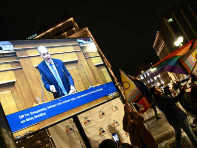 People wait outside the Parliament while the bill on same-sex marriage is debated in Athens, Greece, on February 15, 2024.