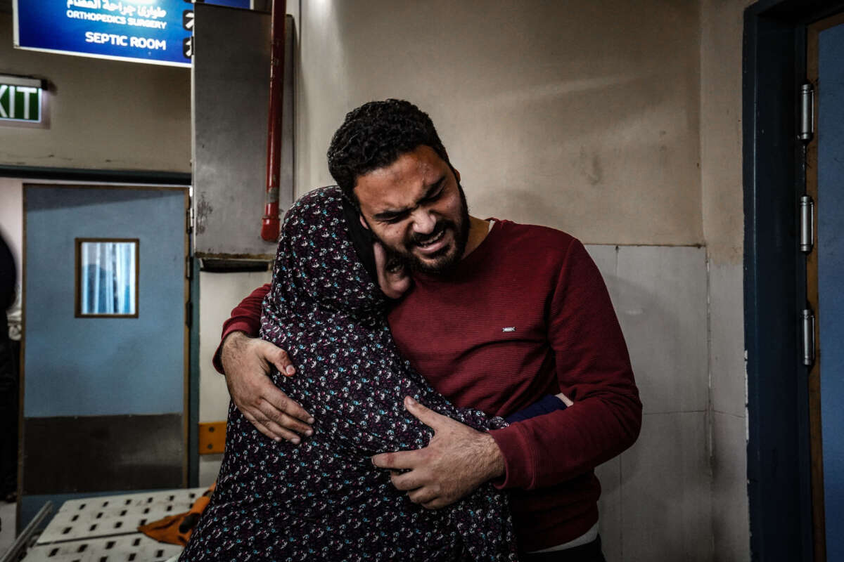 Relatives of Palestinians who died in Israeli attacks mourn as bodies of those killed are brought to the morgue of Nasser Hospital in Khan Yunis, Gaza, on December 27, 2023.