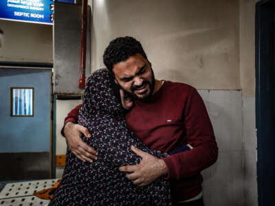 Relatives of Palestinians who died in Israeli attacks mourn as bodies of those killed are brought to the morgue of Nasser Hospital in Khan Yunis, Gaza, on December 27, 2023.