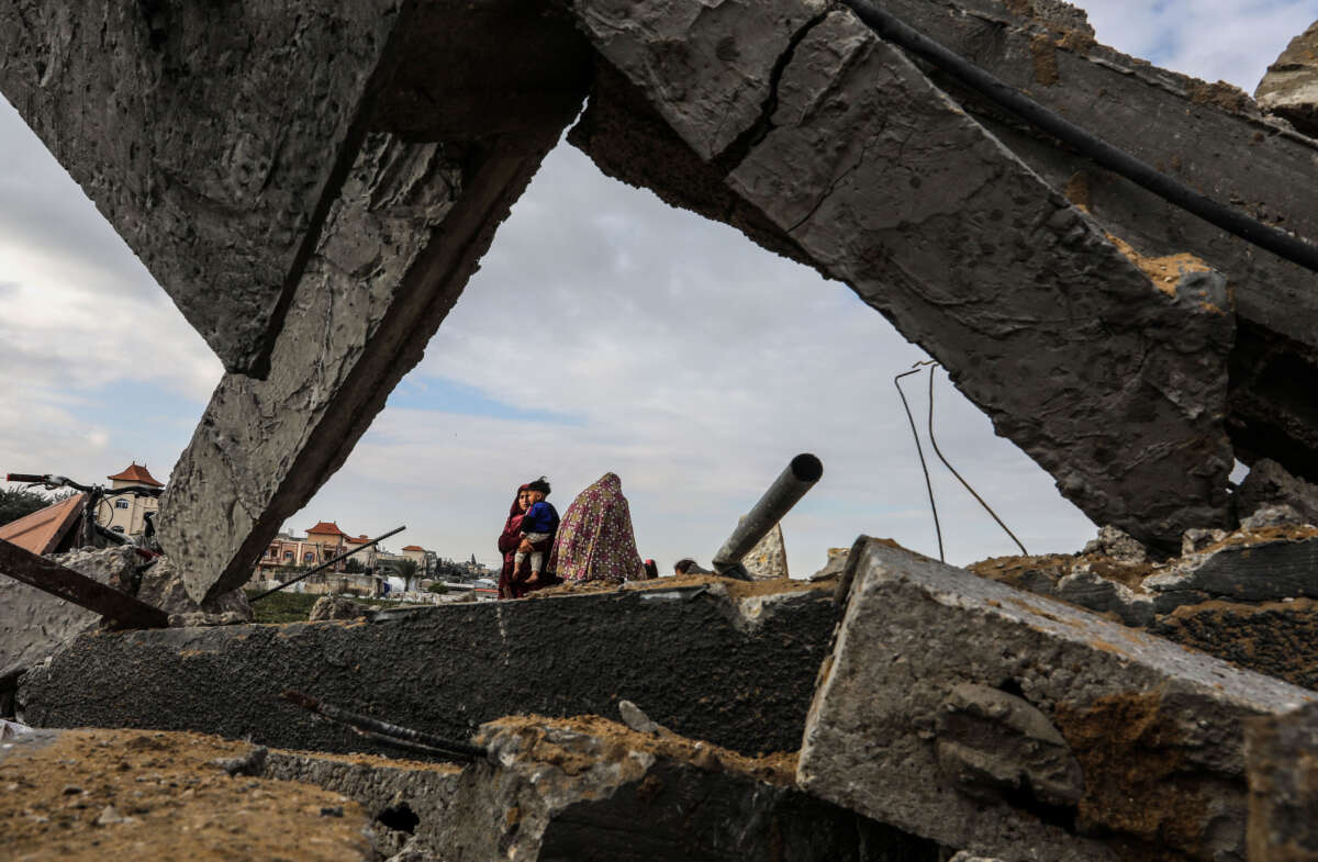 Palestinians inspect the collapsed building following an Israeli strike hit the house belonging to the Abu Nahal family in Rafah, Gaza, on February 18, 2024.
