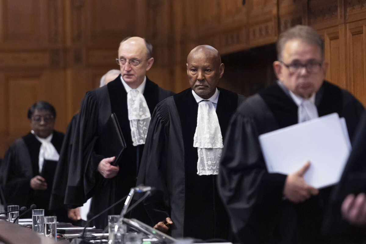Justices from the International Criminal Court walk to their seats