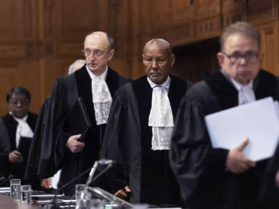 Justices from the International Criminal Court walk to their seats