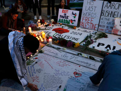 People leave notes and flowers during a vigil for U.S. Air Force active-duty airman Aaron Bushnell outside the Israeli Embassy on February 26, 2024, in Washington, D.C. Bushnell died after setting himself on fire while live streaming, according to published reports, in front of the Israeli Embassy in protest over the ongoing genocide in Palestine.