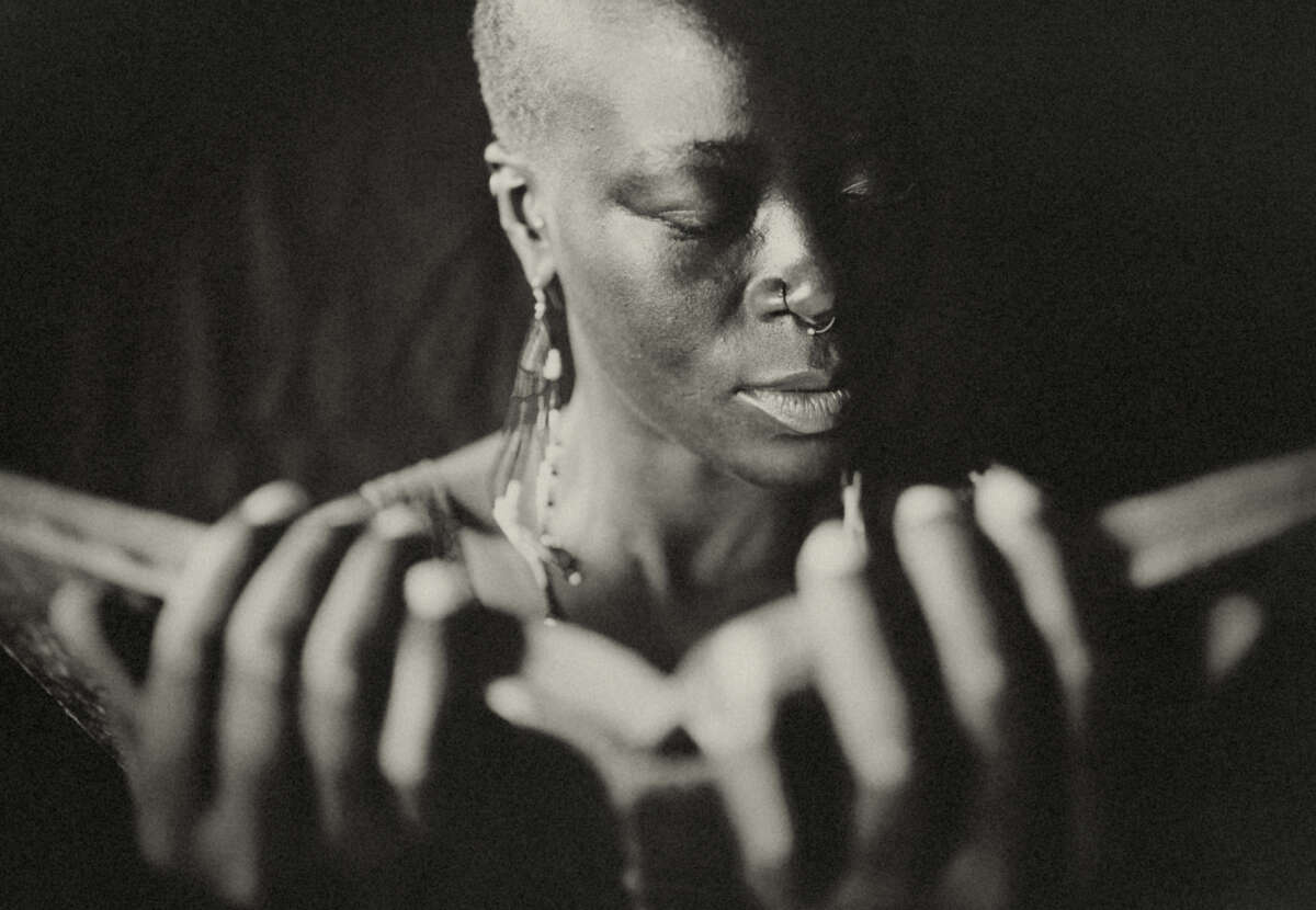 A desaturated photo of a woman reading a book