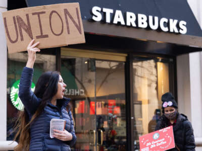 Starbucks workers, former employees, and supporters hold signs in support of a strike, outside of a Starbucks store in Arlington, Virginia, on November 16, 2023.