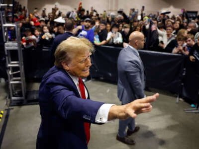 Republican presidential candidate and former President Donald Trump waves to attendees after introducing a new line of signature shoes at Sneaker Con at the Philadelphia Convention Center on February 17, 2024, in Philadelphia, Pennsylvania.