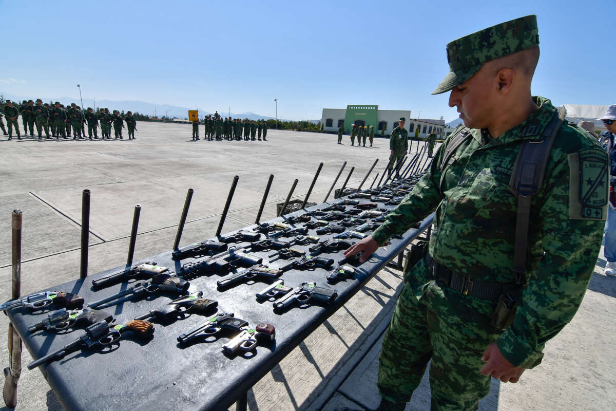 Guns seized from organized crime are laid out for destruction by the Ministry of National Defense on March 22, 2023, in Santa María Rayon, Mexico.