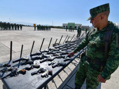 Guns seized from organized crime are laid out for destruction by the Ministry of National Defense on March 22, 2023, in Santa María Rayon, Mexico.