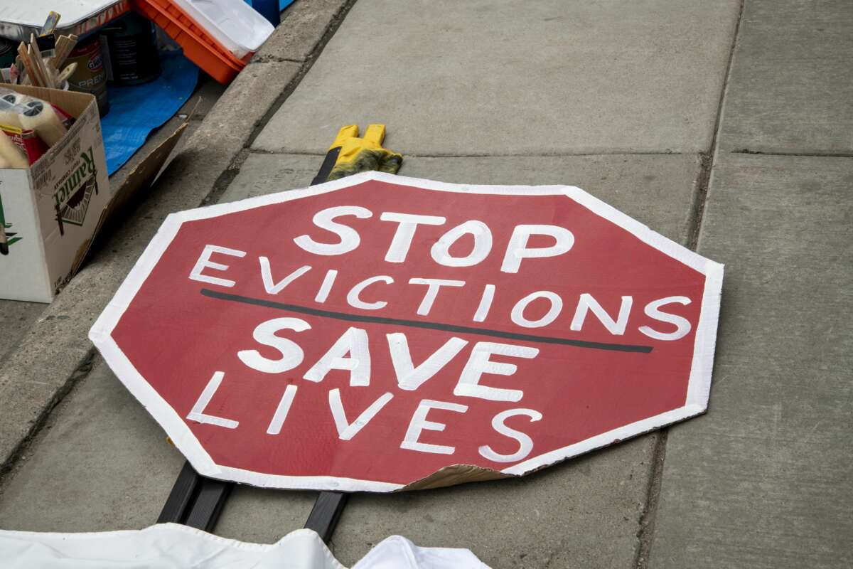 Sign that says "stop evictions save lives"