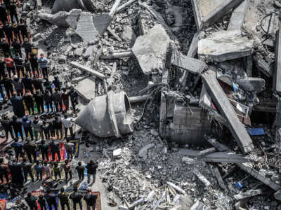 An aerial view of Palestinians performing Friday prayers among the rubble of the Al-Farooq Mosque, destroyed in an Israeli attack, on March 1, 2024, in Rafah, Gaza.