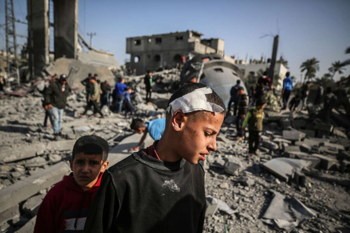 Palestinian children are walking past the rubble of the al-Bukhari mosque in Deir al-Balah, central Gaza Strip, on March 2, 2024, following an overnight Israeli air strike.