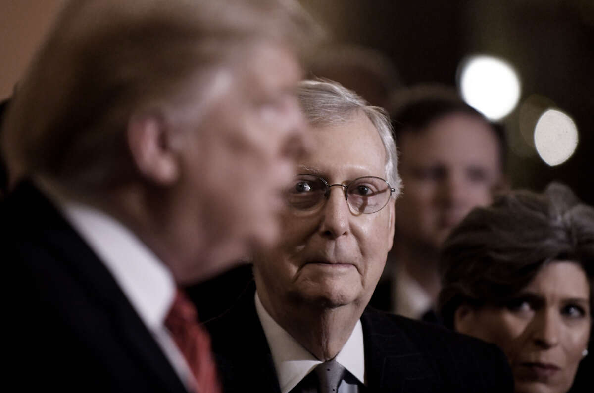 Then-President Donald Trump talks to the press as then-Senate Majority Leader Mitch McConnell looks on after the Republican luncheon at the U.S. Capitol Building on January 9, 2019, in Washington, D.C.