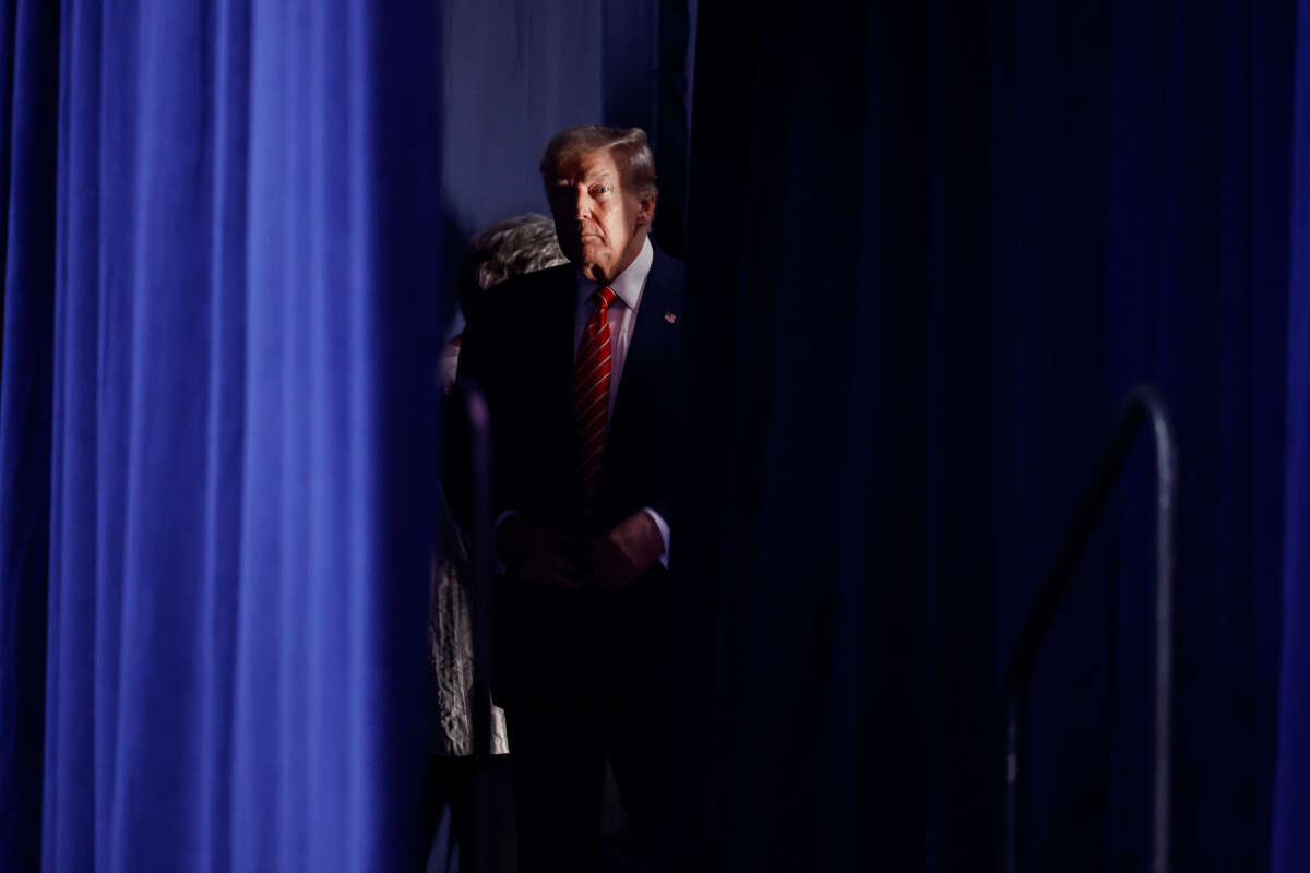 Former President Donald Trump waits to take the stage during a campaign rally at the Forum River Center on March 9, 2024, in Rome, Georgia.