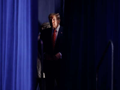 Former President Donald Trump waits to take the stage during a campaign rally at the Forum River Center on March 9, 2024, in Rome, Georgia.