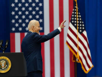 President Joe Biden waves to supporters after speaking at an event about lowering costs for American families at the Granite YMCA Allard Center of Goffstown on March 11, 2024, in Goffstown, New Hampshire.