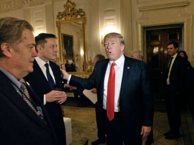 Trump advisor Steve Bannon (left) watches as then-President Donald Trump greets Elon Musk, SpaceX and Tesla CEO, before a policy and strategy forum with executives in the State Dining Room of the White House on February 3, 2017, in Washington, D.C.