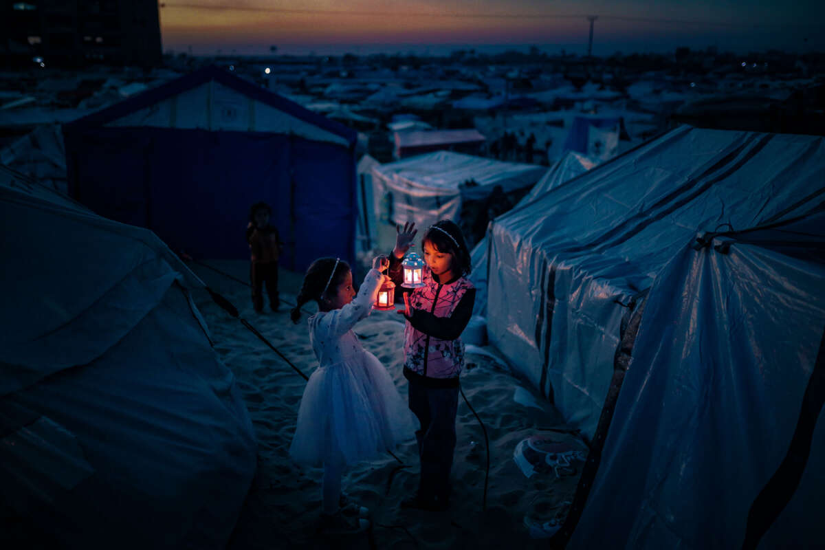 Palestinian children, taking refuge in Tel al-Sultan region due to Israeli attacks, decorate their tents with Ramadan lanterns and illuminate lights ahead of the holy Islamic fasting month of Ramadan in Rafah, Gaza, on February 29, 2024.