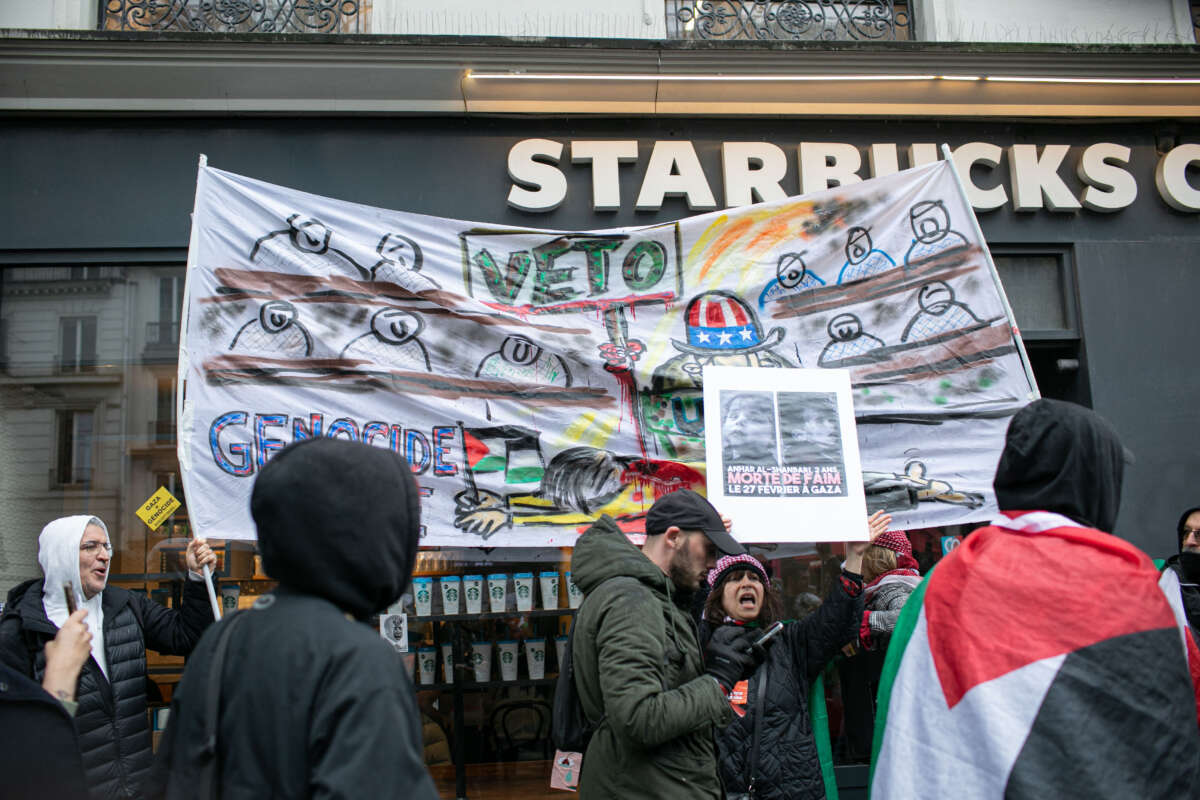 Protesters with a banner reading 'veto genocide Joe,' in front of a Starbucks Coffee at a demonstration in support of the Palestinian people in Paris, France, on March 9, 2024.