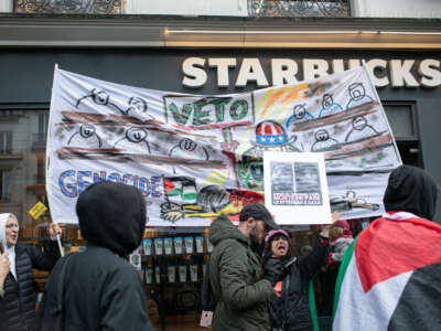 Protesters with a banner reading 'veto genocide Joe,' in front of a Starbucks Coffee at a demonstration in support of the Palestinian people in Paris, France, on March 9, 2024.