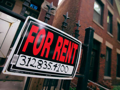 A For Rent sign stands in front of a house in Chicago, Illinois.