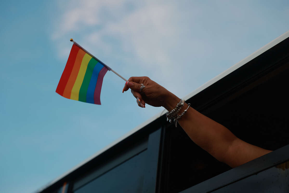 A pride flag is held during the Stonewall Pride parade on June 17, 2023, in Wilton Manors, Florida.