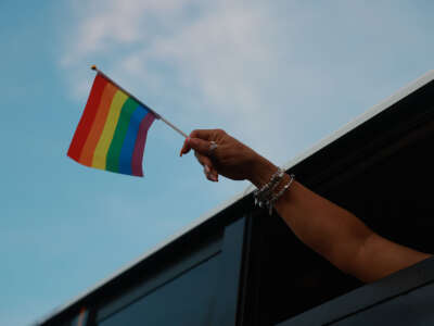 A pride flag is held during the Stonewall Pride parade on June 17, 2023, in Wilton Manors, Florida.